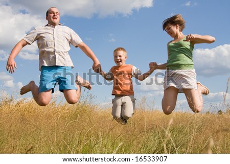 happy family jumping together on a summer day