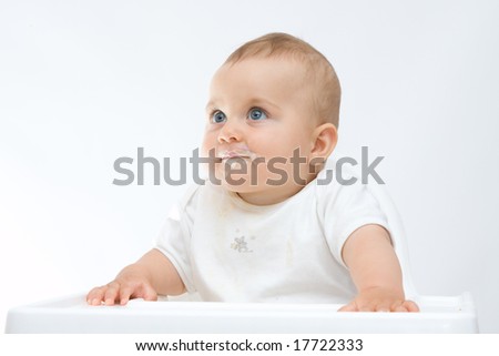 stock photo baby boy with dirty face sitting in highchair