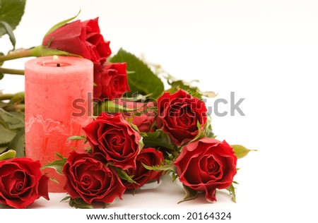 red roses and candle, on white background