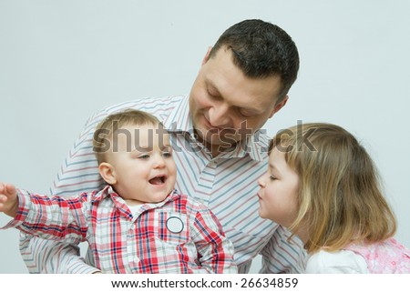 happy siblings with their father, girl kissing her brother
