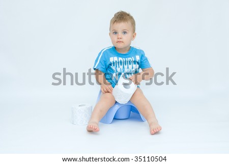 cute, little boy while potty training, on white