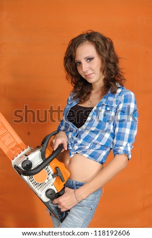 The young woman with a chainsaw on a white background.