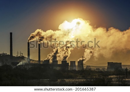 Factory pipe polluting air against sunset, environmental problems