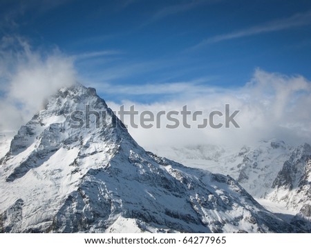 Caucasian mountains, Elbrus, Cheget, wild mountain landscape, snow-clad  high peaks, snow and blue sky