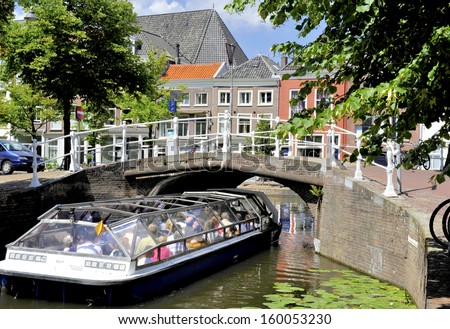 Delft,Holland-July 18,2010;Tourist Sight Seeing Boat Nearing A Bridge Over A Canal. July,18,2010 Delft,Holland