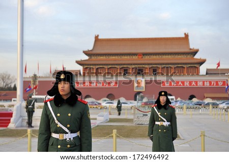 BEIJING,CHINA-DECEMBER 13, 2010: Military guards stand guard in front of the Forbidden City of Beijing at the time that the national flag wil go down,December 13, 2010 Beijing,China