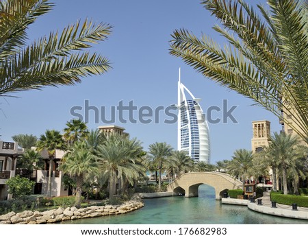 DUBAI, UNITED ARAB EMIRATES - FEBRUARY 8, 2014: View of Burj Al Arab hotel from the Madinat Jumerirah with palm trees . February 8, 2014 Dubai, United Arab Emirates