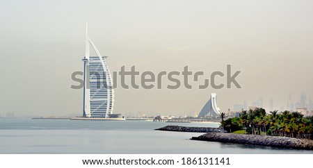 DUBAI, UNITED ARAB EMIRATES - FEBRUARY 9, 2014: View of Burj Al Arab hotel at the sea side. One of the world\'s most luxurious hotels with 7 stars. February 9, 2014 Dubai, United Arab Emirates