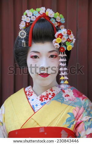 KYOTO,JAPAN - NOVEMBER 4, 2014: Geisha woman in traditional dress.  They are called \'maiko\' in Kyoto and are skilled entertainers and study traditional Japanese arts. November 4, 2014 Kyoto, Japan.