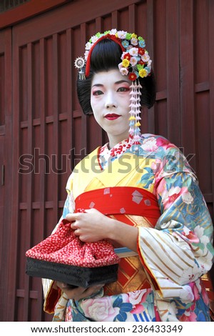 KYOTO,JAPAN - NOVEMBER 4, 2014: Geisha woman in traditional dress. Kyoto is center of Japan\'s traditional culture. Kyoto is the capital of the geisha world.  November 4, 2014 Kyoto, Japan.
