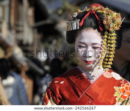 KYOTO,JAPAN - NOVEMBER 4, 2014: Geisha woman in traditional dress. Kyoto is center of Japan\'s traditional geisha culture. They are called \'maiko\' in Kyoto. November 4, 2014 Kyoto, Japan.