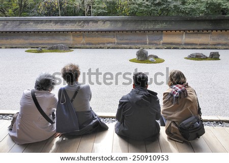 KYOTO, JAPAN-NOVEMBER 10, 2014;Visitors watching the Hojo Zen Rock Garden at the Ryoanji Temple.This is an UNESCO world heritage site. November 10, 2014 Kyoto, Japan