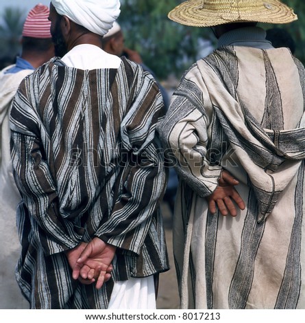 Two Arab man at a market in Morocco; seen from behind
