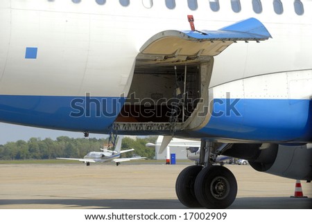 Open hydraulically operated cargo compartment door of an airplane at the airport