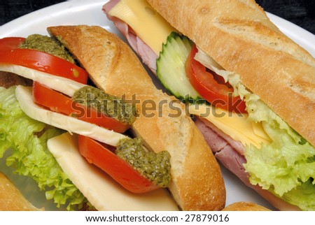 baguette sandwiches with lettuce, tomatoes, ham, cheese and mustard