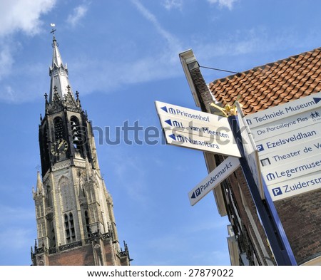 Medieval Delft. View on \'Nieuwe Kerk\' ,at the market square,  last resting places of the Royal Family of the Netherlands.At foreground sign directing to tourist attractions.
