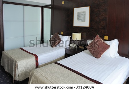 Hotel room with two clean single beds
