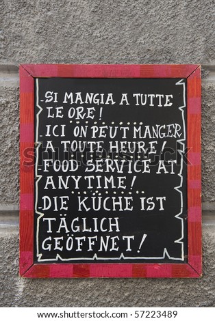 Restaurant sign with text in 4 languages(italian,french,english and german) that you can eat at every moment throughout the day