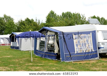 Tents and a caravan at a camping site. NO PEOPLE