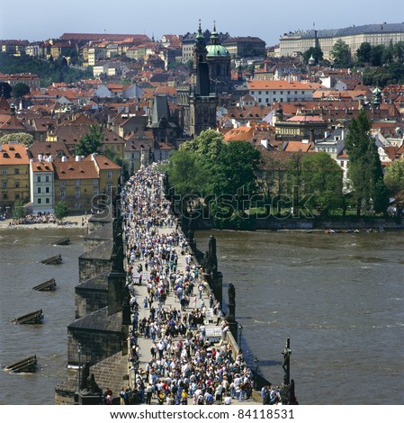 The Charles Bridge over the Vltava river,built in baroque style, in Prague is always crowded with tourists, artists and musicians. The other side of the bridge is called Mala Strana.