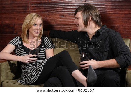 Man and woman laugh during a conversation at wine lounge