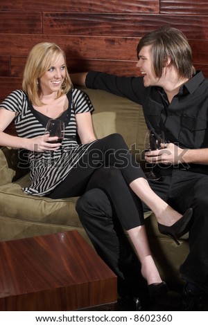 A man and woman talk at a wine lounge