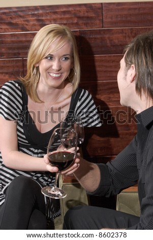 A man and a woman conversate at a wine lounge