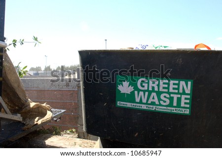 people drop off green yard waste at the recycling plant
