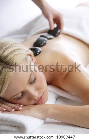 A woman gets a hot stone massage at a day spa