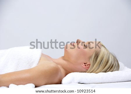 A woman relaxes after getting a massage at a day spa