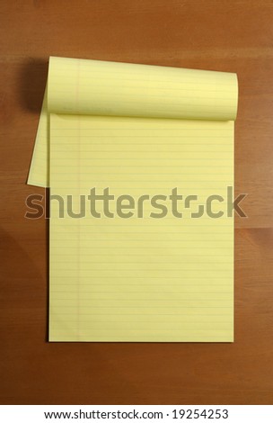 A blank legal pad on an office desk