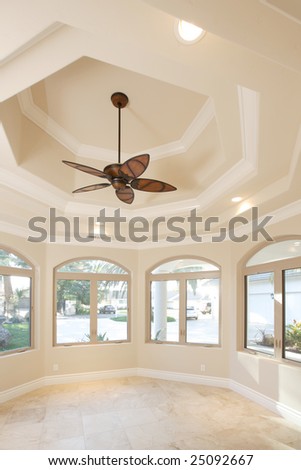 Home office with a vaulted ceiling and fan
