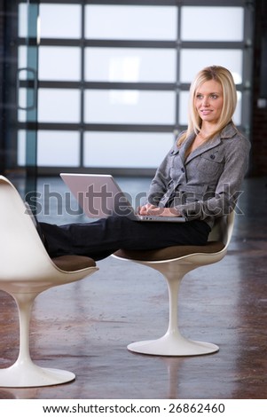 Business woman relaxing with her feet up on a laptop