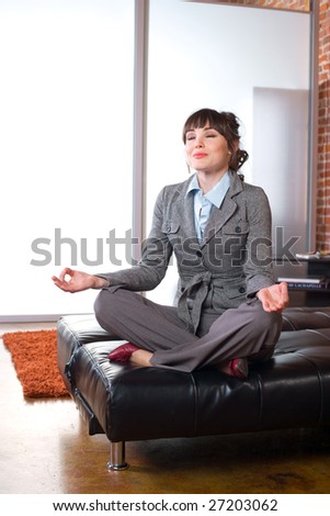 Business woman yoga in a modern office