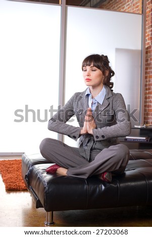 Business woman yoga in a modern office