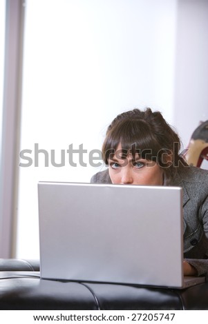 Business Woman on laptop in a modern loft office