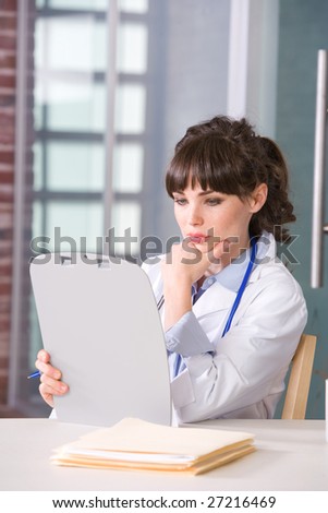 Female doctor in a modern office drinking coffee