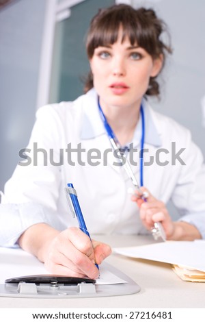 Female doctor in a modern office drinking coffee