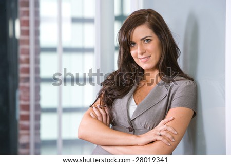 Business woman arms crossed in a modern office