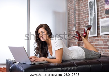 Young Woman on laptop in a modern loft or home