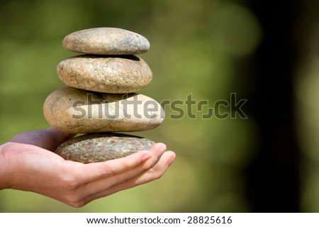 Zen stones stacked on a grass matte at day spa