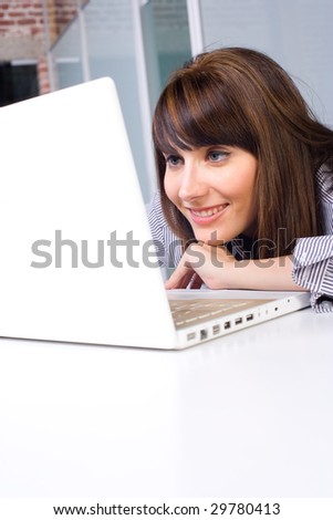 Business Woman on laptop in a modern loft office
