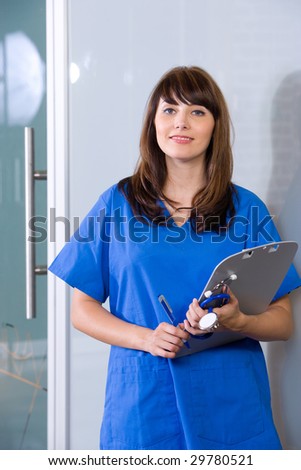 Female Nurse in a modern office holding a chart