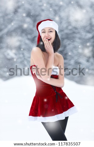 Sexy Snow Maiden on the background of the winter forest