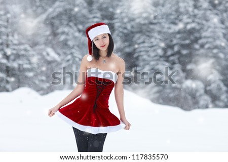 Sexy Snow Maiden on the background of the winter forest