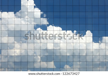Clouds Reflected In Windows Of Modern Office Building