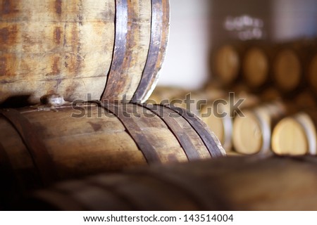 Wine Barrels Stacked In The Old Cellar Of The Winery.