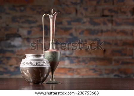 vintage oriental metal vases on wooden desk