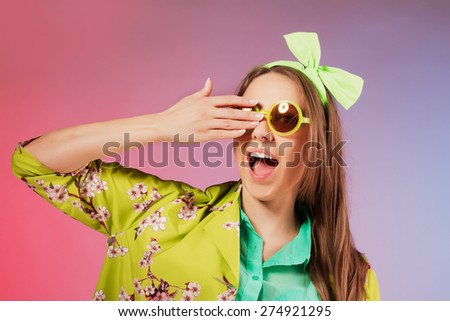 Portrait of a cheerful young girl in bright casual clothes smiling at the camera with beautiful smile.  Colorful background