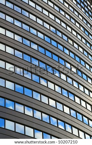 High office building with sky reflecting in the windows